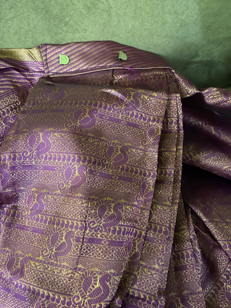 4 yards of fabric purple and gold, patterned, clips on top in the middle