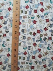 THREAD SPOOLS OF THREAD ON CREAM COTTON FABRIC FQ