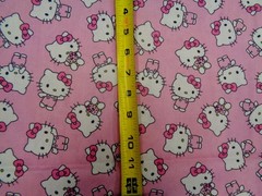 HELLO KITTY TOSSED DESIGN ON PINK BACKGROUND 100% COTTON 1/2 YARD PIECE