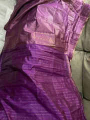 4 yards of fabric purple and gold, patterned, clips on top in the middle