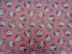 HELLO KITTY TOSSED DESIGN ON PINK BACKGROUND 100% COTTON 1/2 YARD PIECE