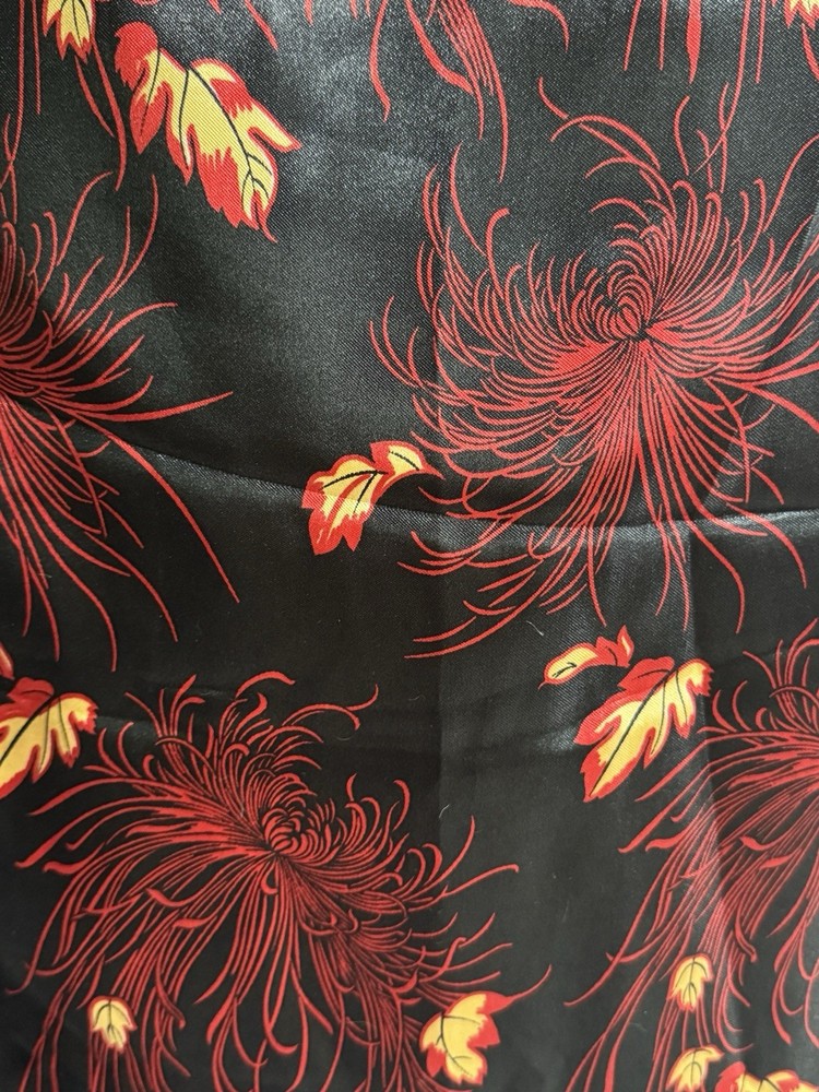 Red and gold on black background Satin Type Fabric 60” w x 36” l leaves