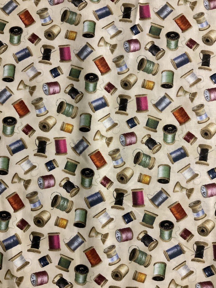 THREAD SPOOLS NEEDLES BOBBINS ON CREAM COTTON FABRIC BTHY